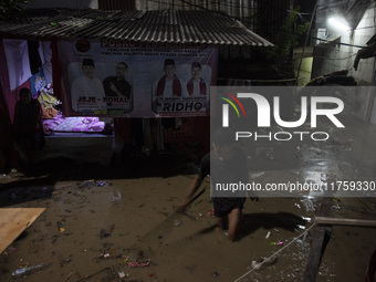 Residents on the riverbanks flee to higher ground when their settlements flood due to the overflow of the Cikeas River after heavy rain for...