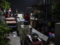 Residents on the riverbanks flee to higher ground when their settlements flood due to the overflow of the Cikeas River after heavy rain for...