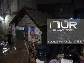 Residents on the riverbanks flee to higher ground when their settlements flood due to the overflow of the Cikeas River after heavy rain for...