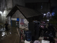 Residents on the riverbanks flee to higher ground when their settlements flood due to the overflow of the Cikeas River after heavy rain for...