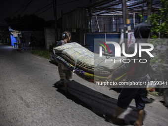 Residents on the riverbanks flee to higher ground when their settlements flood due to the overflow of the Cikeas River after heavy rain for...