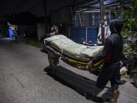 Residents on the riverbanks flee to higher ground when their settlements flood due to the overflow of the Cikeas River after heavy rain for...