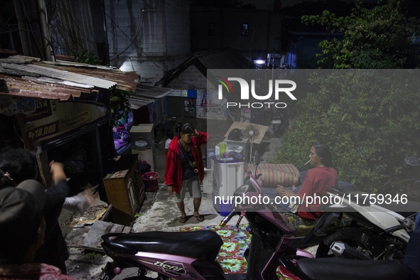 Residents on the riverbanks flee to higher ground when their settlements flood due to the overflow of the Cikeas River after heavy rain for...