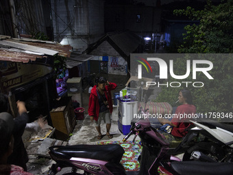 Residents on the riverbanks flee to higher ground when their settlements flood due to the overflow of the Cikeas River after heavy rain for...