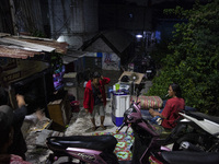 Residents on the riverbanks flee to higher ground when their settlements flood due to the overflow of the Cikeas River after heavy rain for...