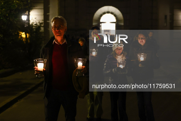 People carry candles during the commemoration event of the 65th anniversary of the Night of Broken Glass (Kristallnacht) in  Berlin, Germany...