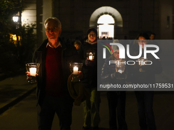 People carry candles during the commemoration event of the 65th anniversary of the Night of Broken Glass (Kristallnacht) in  Berlin, Germany...