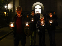 People carry candles during the commemoration event of the 65th anniversary of the Night of Broken Glass (Kristallnacht) in  Berlin, Germany...