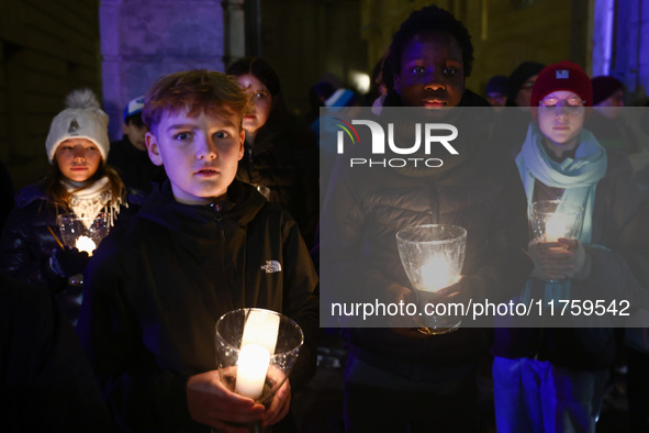 People carry candles during the commemoration event of the 65th anniversary of the Night of Broken Glass (Kristallnacht) in  Berlin, Germany...