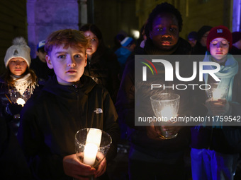 People carry candles during the commemoration event of the 65th anniversary of the Night of Broken Glass (Kristallnacht) in  Berlin, Germany...