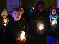 People carry candles during the commemoration event of the 65th anniversary of the Night of Broken Glass (Kristallnacht) in  Berlin, Germany...