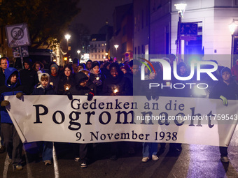 People attend a march commemorating the 65th anniversary of the Night of Broken Glass (Kristallnacht) in  Berlin, Germany on November 9th, 2...