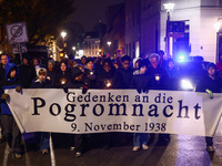 People attend a march commemorating the 65th anniversary of the Night of Broken Glass (Kristallnacht) in  Berlin, Germany on November 9th, 2...