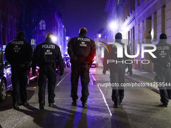 German policemen are protecting a march commemorating the 65th anniversary of the Night of Broken Glass (Kristallnacht) in Berlin, Germany o...