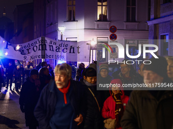 People attend a march commemorating the 65th anniversary of the Night of Broken Glass (Kristallnacht) in  Berlin, Germany on November 9th, 2...