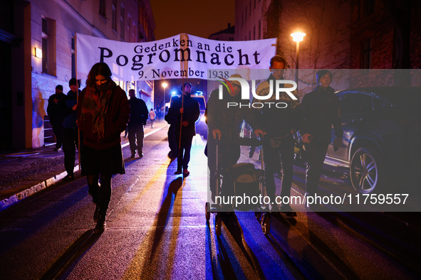 People attend a march commemorating the 65th anniversary of the Night of Broken Glass (Kristallnacht) in  Berlin, Germany on November 9th, 2...