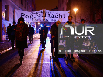 People attend a march commemorating the 65th anniversary of the Night of Broken Glass (Kristallnacht) in  Berlin, Germany on November 9th, 2...