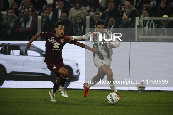 Juventus defender Andrea Cambiaso (27) fights for the ball against Torino midfielder Samuele Ricci (28) during the Serie A football match nu...