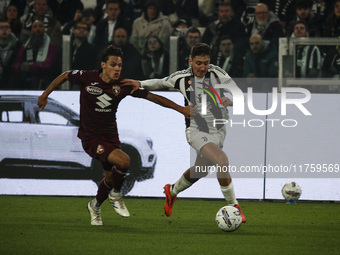 Juventus defender Andrea Cambiaso (27) fights for the ball against Torino midfielder Samuele Ricci (28) during the Serie A football match nu...