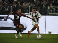 Juventus defender Andrea Cambiaso (27) fights for the ball against Torino midfielder Samuele Ricci (28) during the Serie A football match nu...