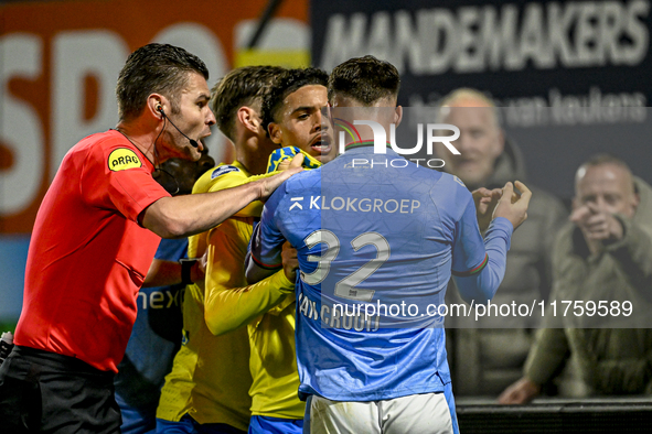 Referee Erwin Blank, RKC midfielder Daouda Weidmann, and NEC forward Vito van Crooij are present during the match between RKC and NEC at the...