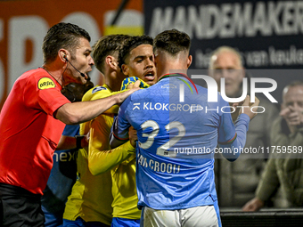 Referee Erwin Blank, RKC midfielder Daouda Weidmann, and NEC forward Vito van Crooij are present during the match between RKC and NEC at the...