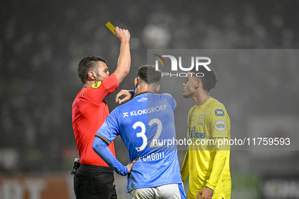 Referee Erwin Blank shows a yellow card to NEC forward Vito van Crooij and RKC midfielder Daouda Weidmann during the match between RKC and N...