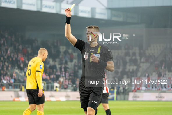 Referee Damian Sylwestrzak shows a yellow card during the game between KS Cracovia and GKS Katowice in Krakow, Poland, on November 9, 2024,...