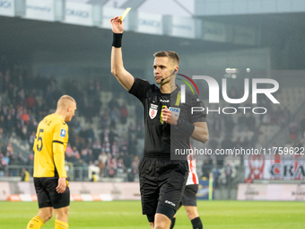 Referee Damian Sylwestrzak shows a yellow card during the game between KS Cracovia and GKS Katowice in Krakow, Poland, on November 9, 2024,...