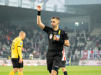 Referee Damian Sylwestrzak shows a yellow card during the game between KS Cracovia and GKS Katowice in Krakow, Poland, on November 9, 2024,...