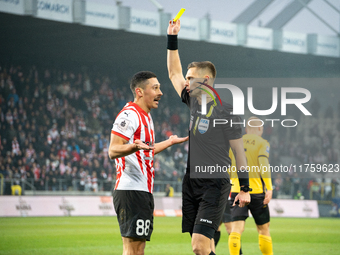 Referee Damian Sylwestrzak shows a yellow card to Patryk Sokolowski during the game between KS Cracovia and GKS Katowice in Krakow, Poland,...