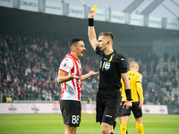 Referee Damian Sylwestrzak shows a yellow card to Patryk Sokolowski during the game between KS Cracovia and GKS Katowice in Krakow, Poland,...