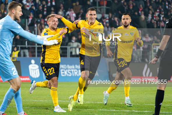 GKS Katowice players Sebastian Milewski, Arkadiusz Jedrych, and Alan Czerwinski celebrate scoring a goal during the game between KS Cracovia...