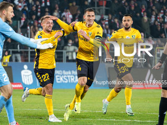 GKS Katowice players Sebastian Milewski, Arkadiusz Jedrych, and Alan Czerwinski celebrate scoring a goal during the game between KS Cracovia...