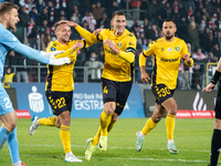 GKS Katowice players Sebastian Milewski, Arkadiusz Jedrych, and Alan Czerwinski celebrate scoring a goal during the game between KS Cracovia...