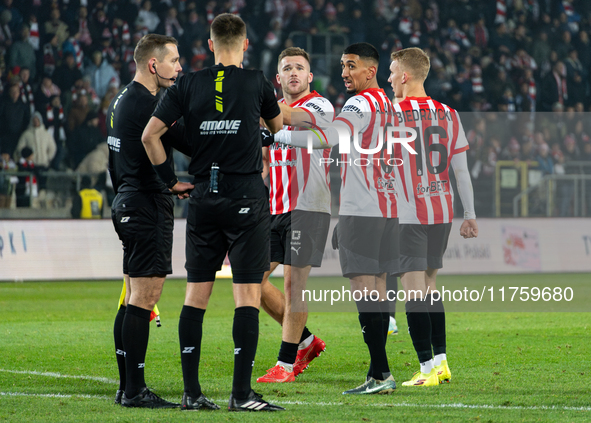 Cracovia players Benjamin Kallman, Amir Al-Ammari, and Bartosz Biedrzycki argue with referees during the game between KS Cracovia and GKS Ka...