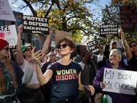 A woman takes selfies as hundreds demonstrate outside The Heritage Foundation for reproductive rights following the election of Donald Trump...