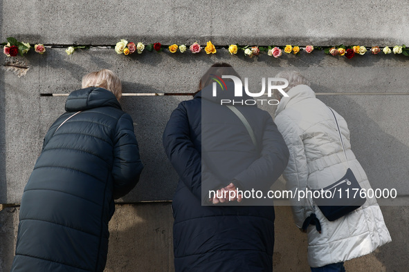 Flowers at Berlin Wall Memorial after the commemoration ceremony marking the 35th anniversary of the fall of the Berlin Wall. Berlin, German...