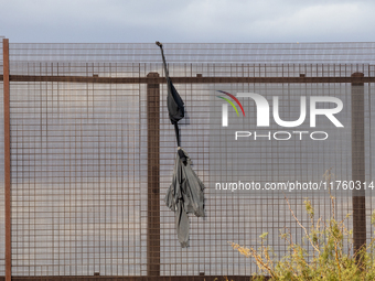 A sweatshirt hangs from the border wall between Ciudad Juarez, Mexico, and El Paso, United States, seemingly placed by migrants as support t...