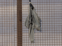 A sweatshirt hangs from the border wall between Ciudad Juarez, Mexico, and El Paso, United States, seemingly placed by migrants as support t...