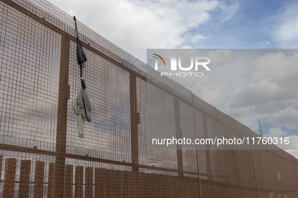 A sweatshirt hangs from the border wall between Ciudad Juarez, Mexico, and El Paso, United States, seemingly placed by migrants as support t...