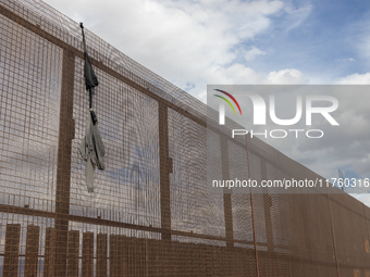 A sweatshirt hangs from the border wall between Ciudad Juarez, Mexico, and El Paso, United States, seemingly placed by migrants as support t...