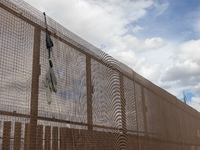 A sweatshirt hangs from the border wall between Ciudad Juarez, Mexico, and El Paso, United States, seemingly placed by migrants as support t...