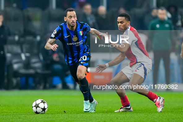 Hakan Calhanoglu of FC Internazionale and Jurrien Timber of Arsenal compete for the ball during the UEFA Champions League 2024/25 League Pha...