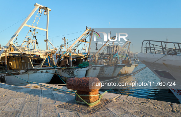 Fishing boats moor at the pier in Mola di Bari harbor, Italy, on July 3, 2024. The traditional vessels play a vital role in the local fishin...