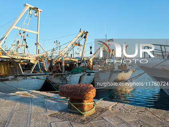 Fishing boats moor at the pier in Mola di Bari harbor, Italy, on July 3, 2024. The traditional vessels play a vital role in the local fishin...