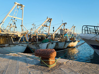 Fishing boats moor at the pier in Mola di Bari harbor, Italy, on July 3, 2024. The traditional vessels play a vital role in the local fishin...