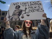 Abortion rights activists gather in front of the Heritage Foundation building during the Women's March in Washington DC, on November 9, 2024...