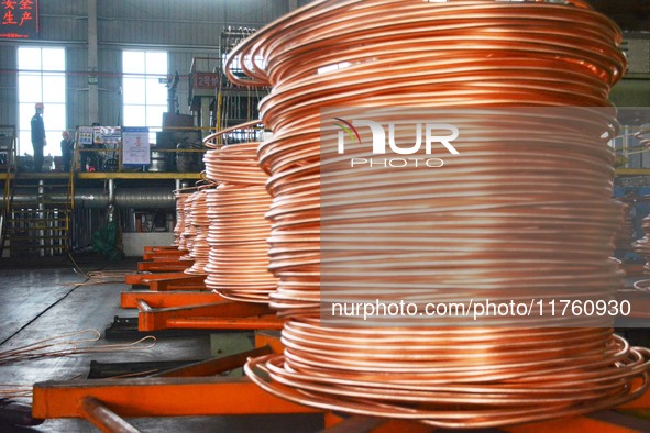 A worker of Yangfan Copper (Anhui) Co LTD works on a production line at the Yuexi County Economic Development Zone in Anqing, China, on Nove...