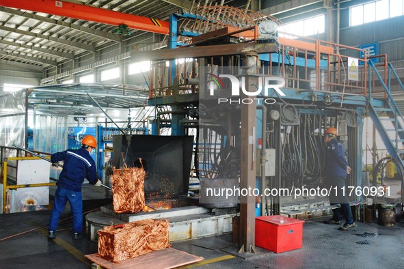 A worker of Yangfan Copper (Anhui) Co LTD works on a production line at the Yuexi County Economic Development Zone in Anqing, China, on Nove...